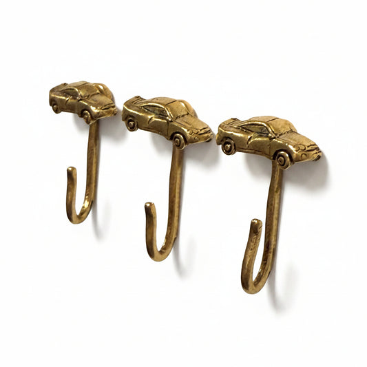 Car decorative metal push pin hooks in gold for hanging pictures, jewelry, photos, and lightweight decor. 